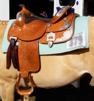 Despite the tooling you can use polish on this style of saddle, just be careful of the metal!